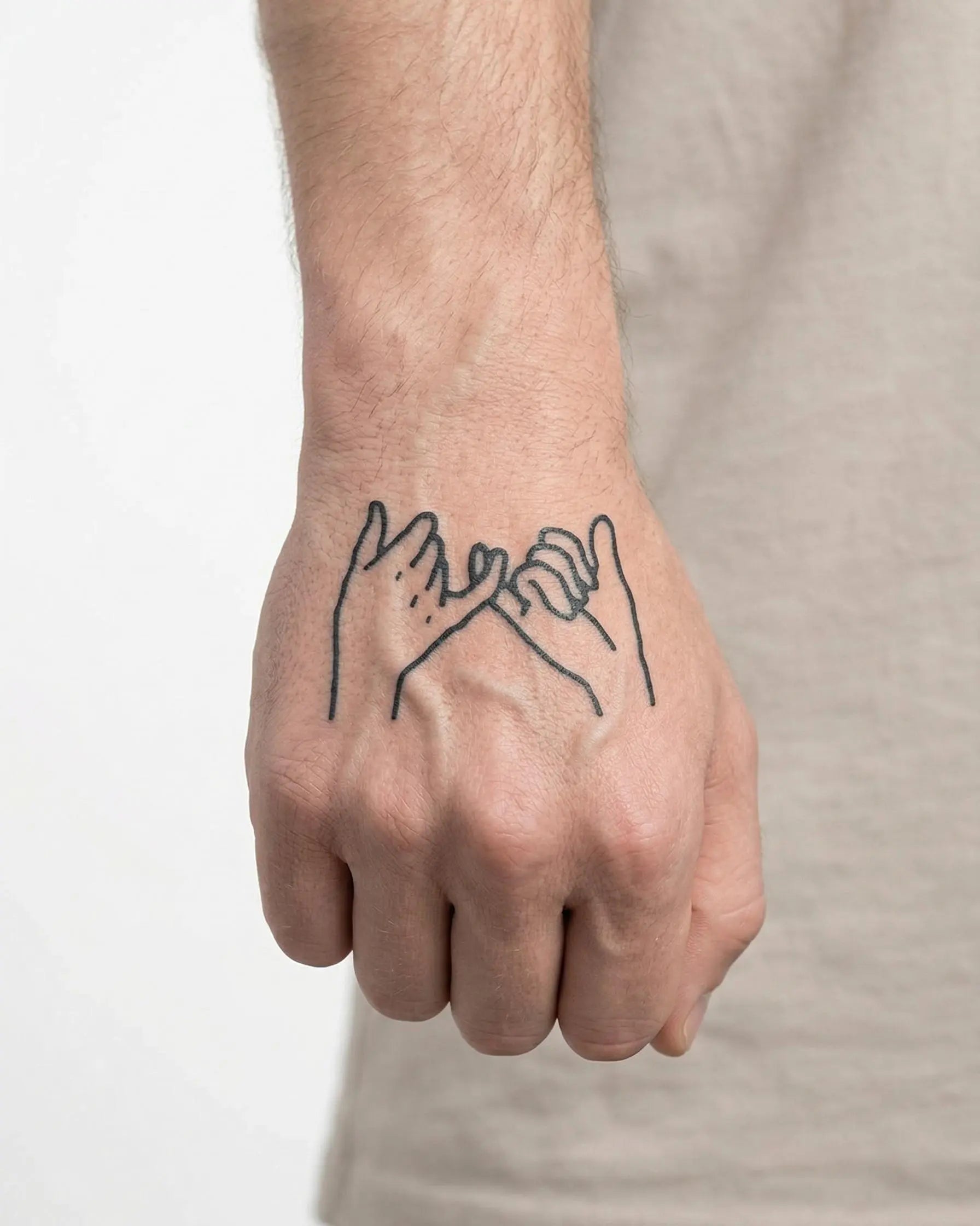 INKON Pinky Promise 2 semi-permanent tattoo applied on a man – 2 x 2 in (5x5cm) design, realistic ink look, lasts 10 days
